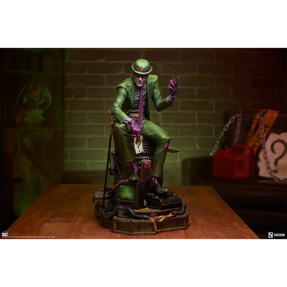 The Riddler sitting down looking at the camera